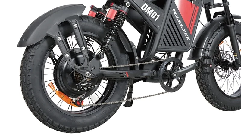 Close-up of 1000W electric motor and fat tires on dirt trail bike
