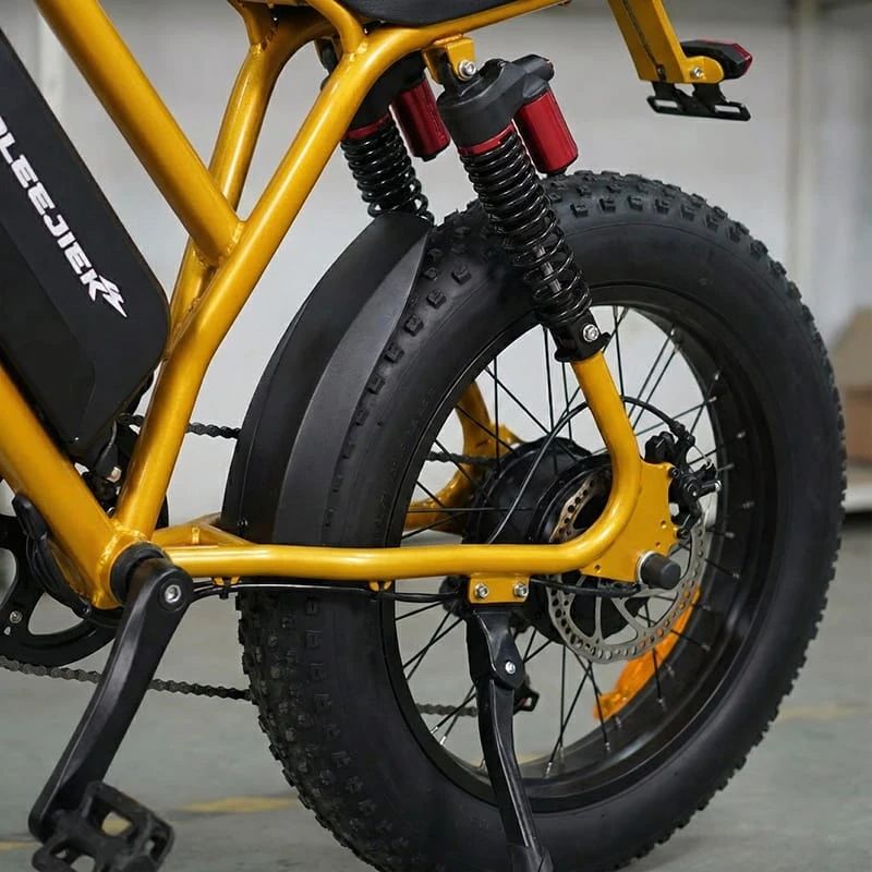 Detail shot of the 4-inch fat tires and reinforced steel frame of the F6 electric dirt bike, designed for rugged terrain and all-weather durability.