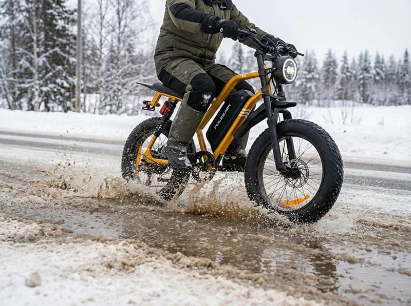The POLEEJIEK F6 riding through wet winter slush and melting snow, highlighting its IP54 waterproof rating and sealed motor components.