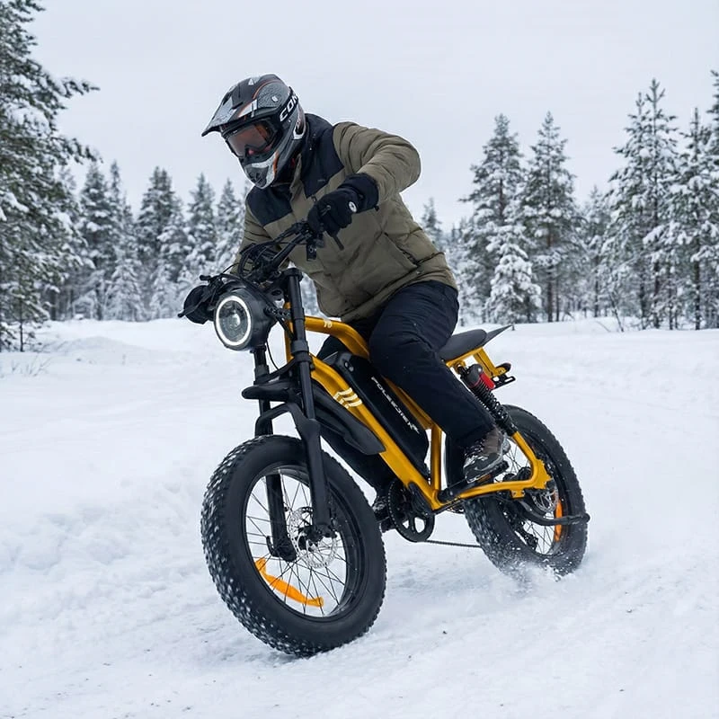 An electric dirt bike rider maintaining a centered body position and loose arms while cornering on a snowy trail to prevent sliding.