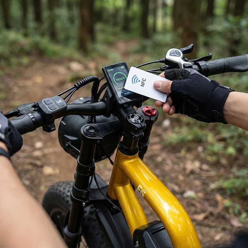 A rider's hand using an NFC card to tap the LCD display of the F6 electric bike, demonstrating the keyless ignition system.